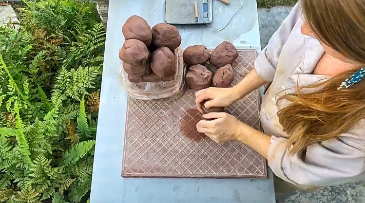 Load video: A video of Cheer preparing the clay for the first (&quot;bisque&quot;) firing.